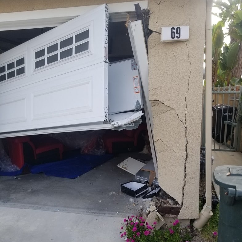 damaged garage door in need of repair